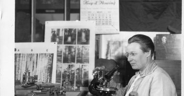 A scientist working with a microscope in a laboratory